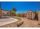 Backyard with covered patio, storage shed, and desert-friendly landscaping and cactus at 15022 N 22Nd Ln, Phoenix, AZ 85023