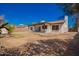 Backyard area features desert landscaping, covered patio, and charming brick accents at 15022 N 22Nd Ln, Phoenix, AZ 85023