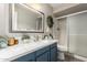 Bright bathroom with a white countertop and blue vanity cabinets at 15022 N 22Nd Ln, Phoenix, AZ 85023