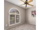 Bright bedroom featuring a large window with white shutters and ceiling fan at 15022 N 22Nd Ln, Phoenix, AZ 85023