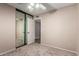 This bedroom has neutral colors, plush carpet, mirrored closet doors and ceiling fan at 15022 N 22Nd Ln, Phoenix, AZ 85023