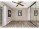 Comfortable bedroom featuring a ceiling fan and mirrored closet at 15022 N 22Nd Ln, Phoenix, AZ 85023