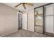 Bedroom view includes open door to bath and mirrored closet with fan reflection at 15022 N 22Nd Ln, Phoenix, AZ 85023