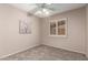 A serene bedroom has neutral walls, plush carpet, and a bright, shuttered window at 15022 N 22Nd Ln, Phoenix, AZ 85023