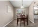 Formal dining room featuring an ornate light fixture and window with white shutters at 15022 N 22Nd Ln, Phoenix, AZ 85023
