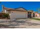 Spacious two-car garage of a single-story home, complemented by desert landscaping and a well-maintained exterior at 15022 N 22Nd Ln, Phoenix, AZ 85023