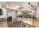 Bright kitchen featuring granite countertops, white cabinets, recessed lighting, and a view into the dining area at 15022 N 22Nd Ln, Phoenix, AZ 85023
