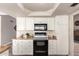 Well-lit kitchen with white cabinets, granite counters, a black range, and ample counter space for cooking at 15022 N 22Nd Ln, Phoenix, AZ 85023
