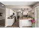 Open kitchen boasts white cabinets, granite counters, modern appliances, and a seamless view of the adjacent dining area at 15022 N 22Nd Ln, Phoenix, AZ 85023