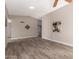 Open living room featuring neutral paint, vaulted ceiling, and wood-look tile flooring at 15022 N 22Nd Ln, Phoenix, AZ 85023