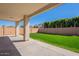 Outdoor patio with a view of a well maintained lawn and block wall, perfect for relaxation and entertainment at 18123 W Lundberg St, Surprise, AZ 85388