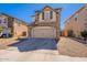 Charming two-story home featuring a stone facade, attached garage, and a well-maintained front yard at 18123 W Lundberg St, Surprise, AZ 85388