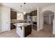 Stylish kitchen showcasing granite countertops, dark cabinets, stainless steel appliances, and kitchen island at 18123 W Lundberg St, Surprise, AZ 85388