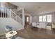 Bright living room features modern flooring, neutral colors, and a staircase with white banisters at 18123 W Lundberg St, Surprise, AZ 85388