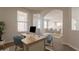 Bright office space featuring a large window, desk, and neutral color palette at 18123 W Lundberg St, Surprise, AZ 85388