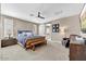 Spacious bedroom features a barn door entrance to the bathroom, and a ceiling fan at 18572 N 94Th St, Scottsdale, AZ 85255