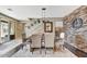 Charming dining room boasts brick accent wall, hardwood floors, and seating for six at 18572 N 94Th St, Scottsdale, AZ 85255