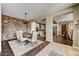 Elegant dining area flows into the kitchen, featuring a modern table and brick accent wall at 18572 N 94Th St, Scottsdale, AZ 85255