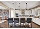 Eat-in kitchen features a beautiful island with barstool seating, stainless appliances and custom cabinetry at 18572 N 94Th St, Scottsdale, AZ 85255