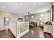 Cozy living room featuring hardwood floors, leather sofa, and a ceiling fan at 18572 N 94Th St, Scottsdale, AZ 85255