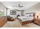 Comfortable main bedroom with ceiling fan, wood furniture, and a cozy sitting area bathed in natural light at 18572 N 94Th St, Scottsdale, AZ 85255