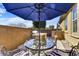 Cozy backyard patio features an outdoor dining area with seating, built-in barbecue, and a relaxing shaded umbrella at 18572 N 94Th St, Scottsdale, AZ 85255