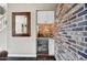 Stylish wet bar featuring a wine fridge, granite countertop, and brick accent wall at 18572 N 94Th St, Scottsdale, AZ 85255
