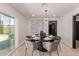 Chic dining room with a unique chandelier, table set for six, and sliding glass doors at 1922 W Joan De Arc Ave, Phoenix, AZ 85029