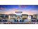 Community pool with modern building, outdoor seating and desert landscaping with beautiful blue skies in the background at 2121 W Sonoran Desert Dr # 126, Phoenix, AZ 85085