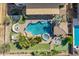 Aerial view of the backyard showcasing a pool, spa, putting green, and covered seating areas at 21256 E Waverly Dr, Queen Creek, AZ 85142