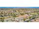 Wide aerial shot displays a residential neighborhood with numerous homes and well-maintained landscaping under a clear sky at 21256 E Waverly Dr, Queen Creek, AZ 85142