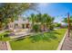Lush backyard featuring artificial turf, mature trees, and a charming swing, ideal for outdoor activities at 21256 E Waverly Dr, Queen Creek, AZ 85142