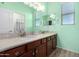 A well-lit bathroom with dual sinks, private mirror, and hardwood cabinets at 21256 E Waverly Dr, Queen Creek, AZ 85142