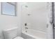 Well-lit bathroom featuring a shower-over-tub and white tile at 21256 E Waverly Dr, Queen Creek, AZ 85142