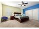 A comfortably furnished bedroom with modern ceiling fan, and private closet at 21256 E Waverly Dr, Queen Creek, AZ 85142