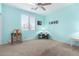 Bright bedroom with a ceiling fan, window, desk and LOVE decorations at 21256 E Waverly Dr, Queen Creek, AZ 85142