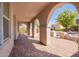 Covered patio with brick flooring, elegant arches, and views of the surrounding neighborhood at 21256 E Waverly Dr, Queen Creek, AZ 85142