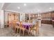 Open concept dining area featuring hardwood floors, wooden dining table and chairs, and decorative china cabinet at 21256 E Waverly Dr, Queen Creek, AZ 85142