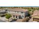 Two-story home features a covered porch, desert landscaping, and well-maintained lawn at 21256 E Waverly Dr, Queen Creek, AZ 85142