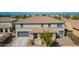 Inviting two-story home with a well-manicured yard boasts an attractive exterior elevation and curb appeal at 21256 E Waverly Dr, Queen Creek, AZ 85142