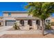 Beautiful two-story home featuring manicured landscaping, a gray garage door, and inviting covered porch at 21256 E Waverly Dr, Queen Creek, AZ 85142