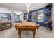 This game room boasts a handsome pool table, carpeted floors, and neutral colored walls at 21256 E Waverly Dr, Queen Creek, AZ 85142