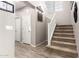 Inviting hallway with staircase and neutral color palette, showcasing modern lighting and carpeted stairs to the upper level at 21256 E Waverly Dr, Queen Creek, AZ 85142