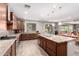 Well-equipped kitchen featuring granite countertops, stainless steel appliances, seamless backsplash, and a large center island at 21256 E Waverly Dr, Queen Creek, AZ 85142