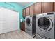 Laundry room with modern washer and dryer, storage cabinets, and counter space at 21256 E Waverly Dr, Queen Creek, AZ 85142