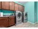Laundry room with a modern washer and dryer with cabinets and sink at 21256 E Waverly Dr, Queen Creek, AZ 85142