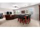 Spacious living area with carpeting, a ceiling fan, a wall-mounted TV, and a dining area with modern seating at 21256 E Waverly Dr, Queen Creek, AZ 85142