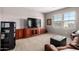 Comfortable living room with a large tv, custom cabinets, and plush seating at 21256 E Waverly Dr, Queen Creek, AZ 85142