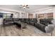 This hardwood living room features a large seating area and an open concept that connects to the kitchen at 21256 E Waverly Dr, Queen Creek, AZ 85142