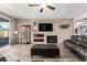 This living room features a stone fireplace, built-in cabinet features and hardwood floors at 21256 E Waverly Dr, Queen Creek, AZ 85142